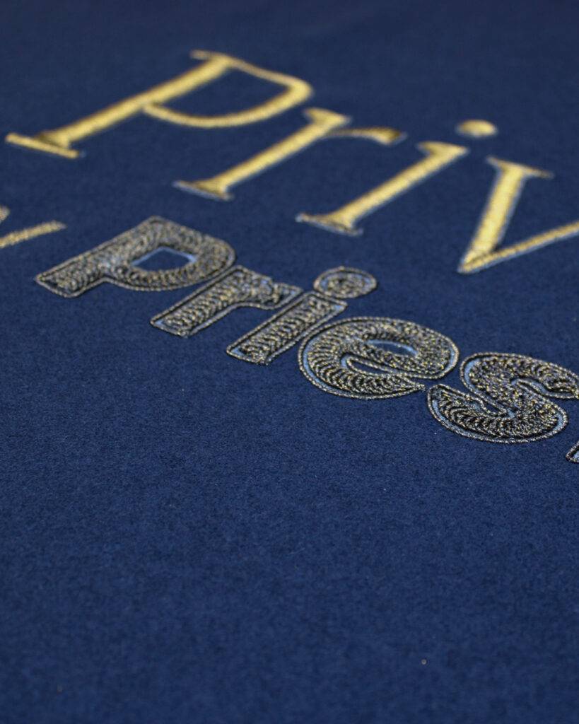 Navy Blue Fabric with Gold Private Studio by PriestmanGoode embroidered on using various techniques